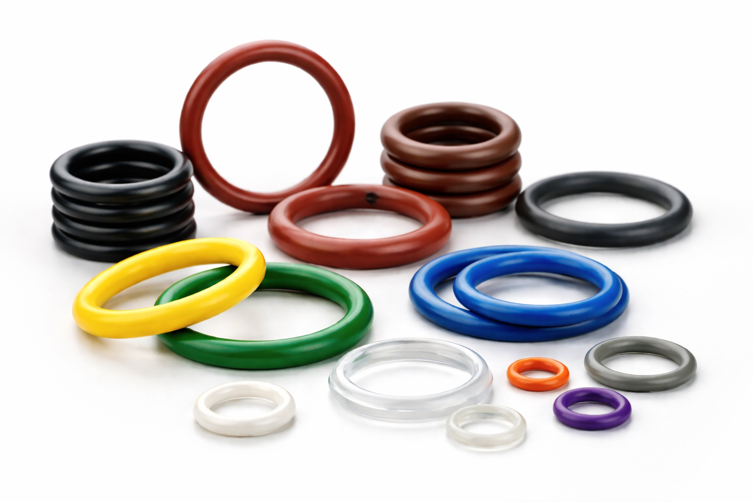 Colored O-rings in various sizes and materials on a white background.